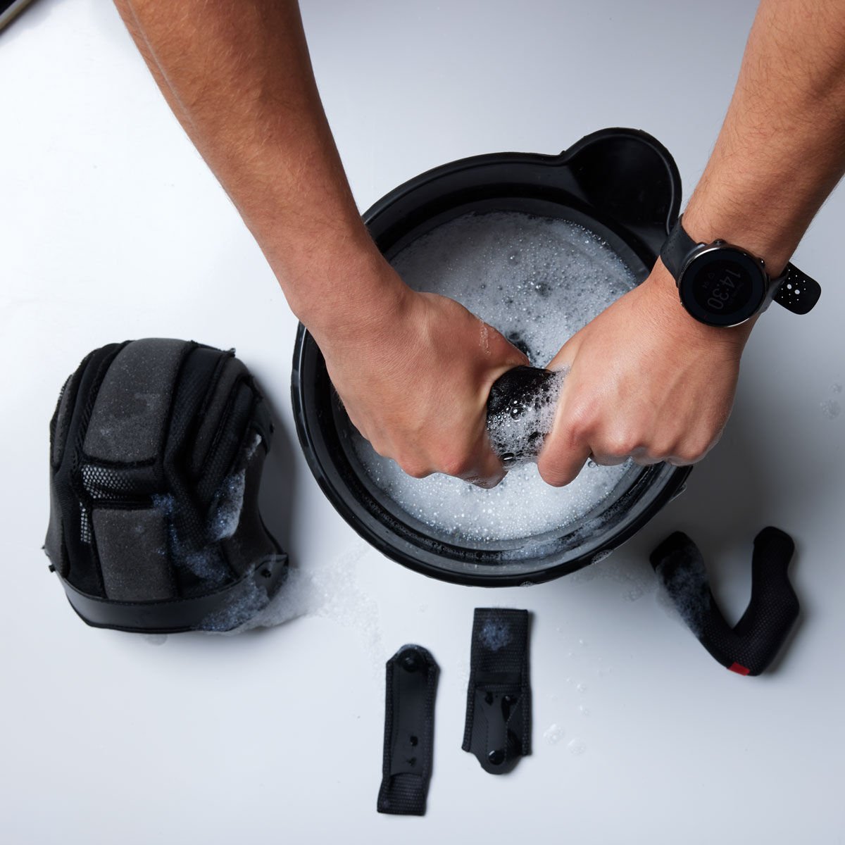 Wring out a cloth over a bucket. Wring out a cloth over a bucket.